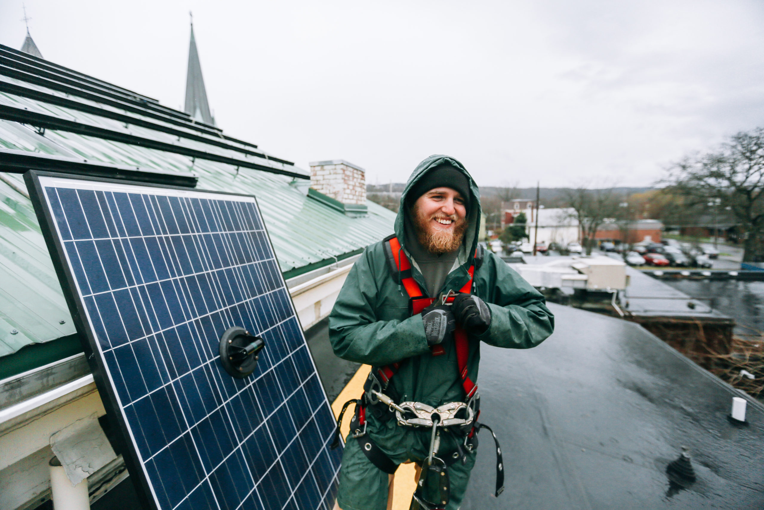Man installing solar panels on roof
